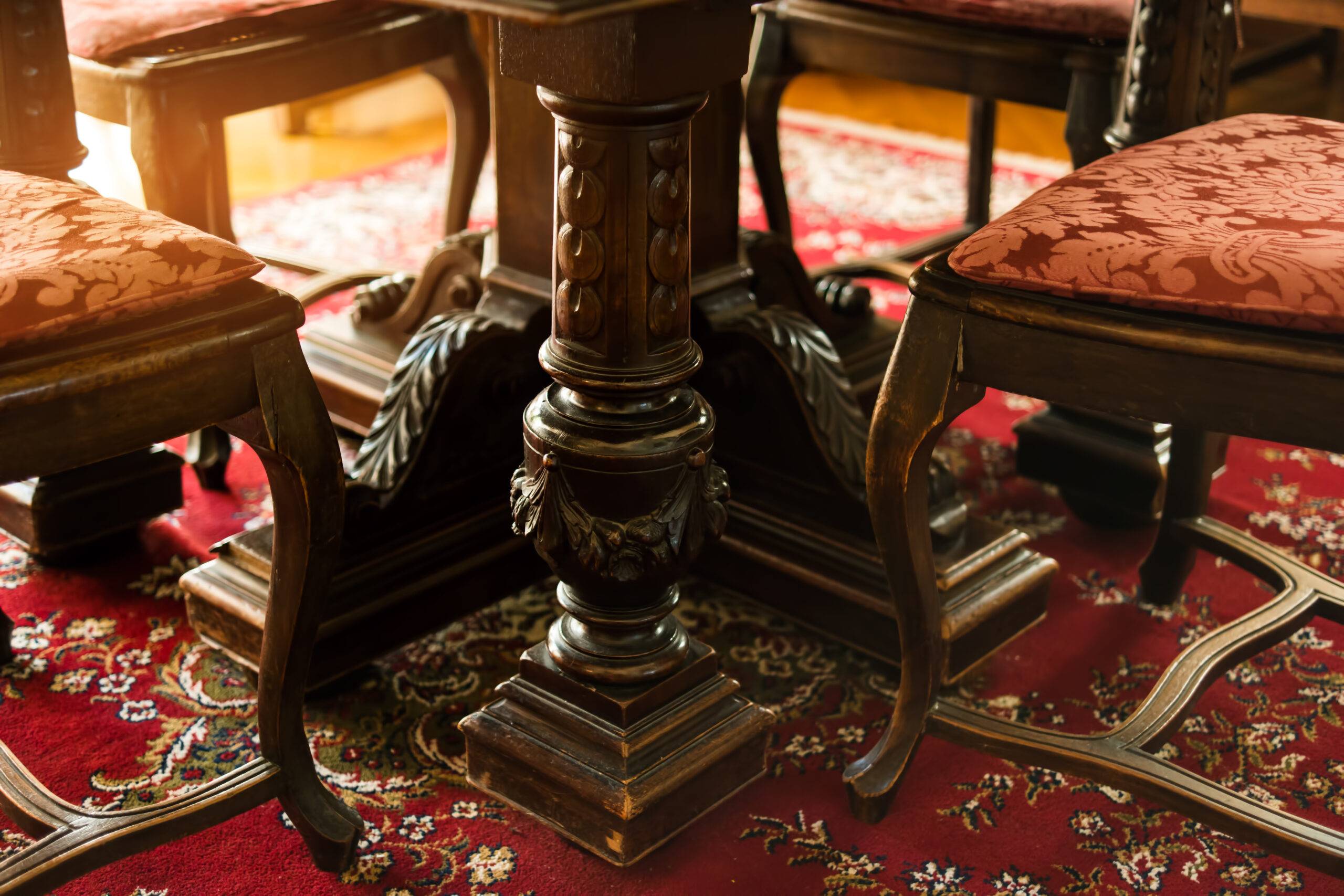 Antique wood furniture. Classic chairs on the carpet. The art of carving.