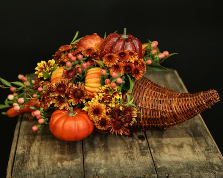 a cornucopia filled with flowers and fall accessories