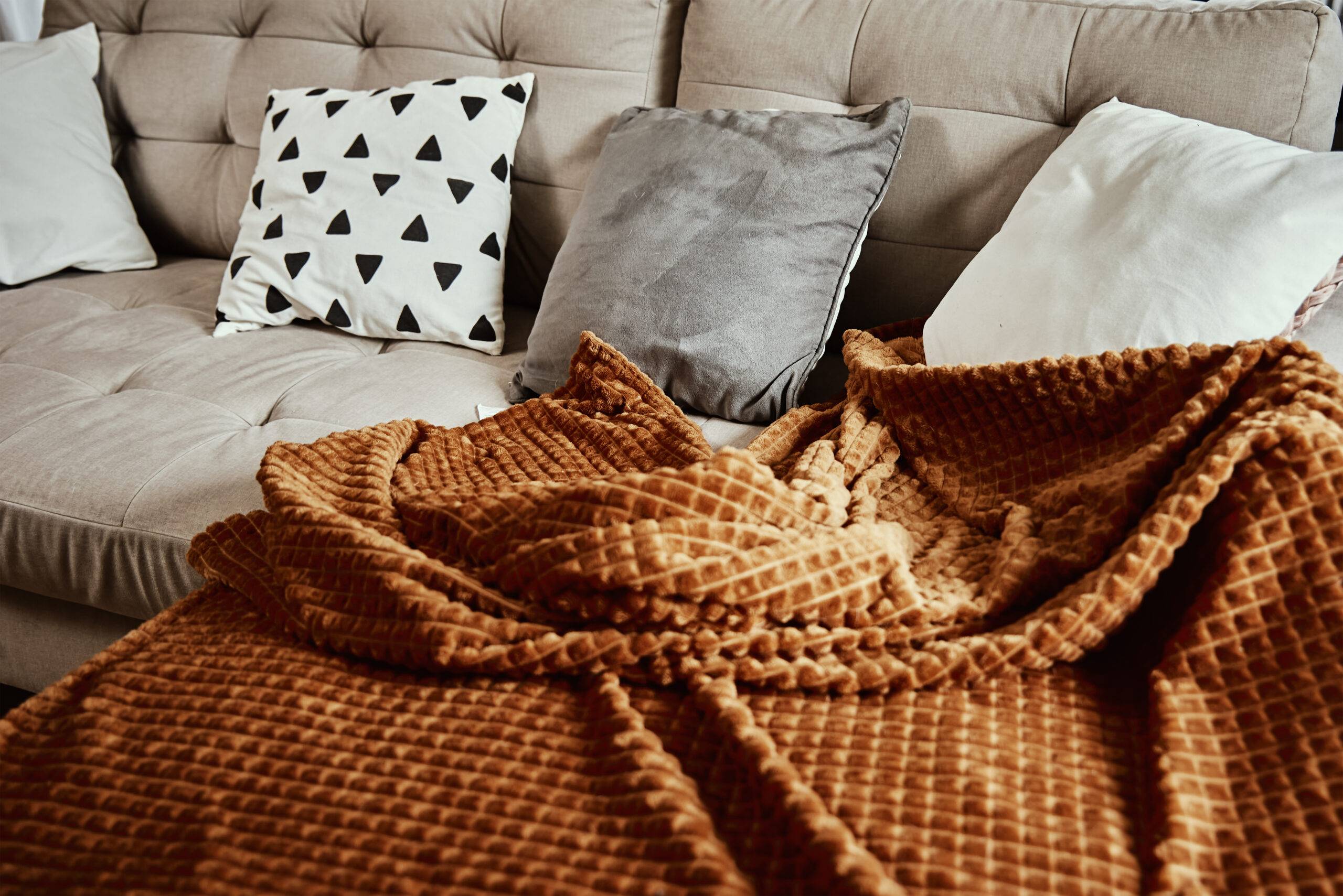 Empty couch with plaid and pillows. Place for relax, cozy home