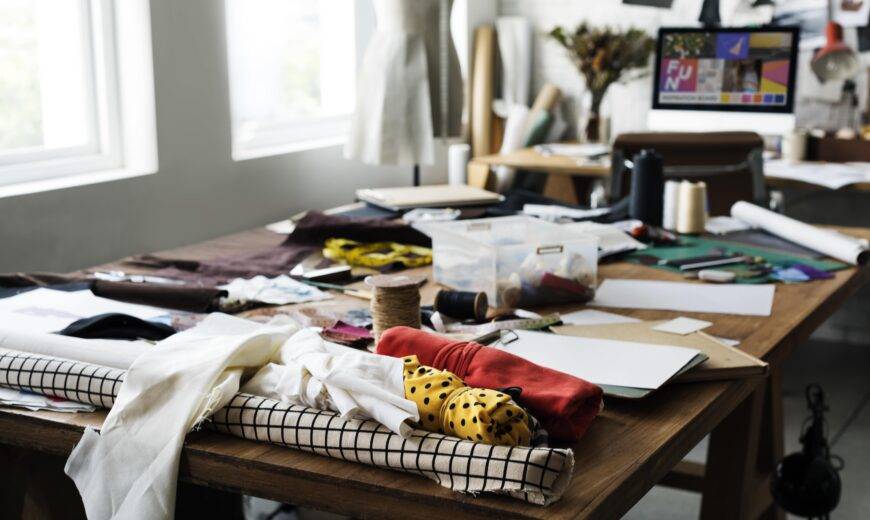 A table covered in various clutter.