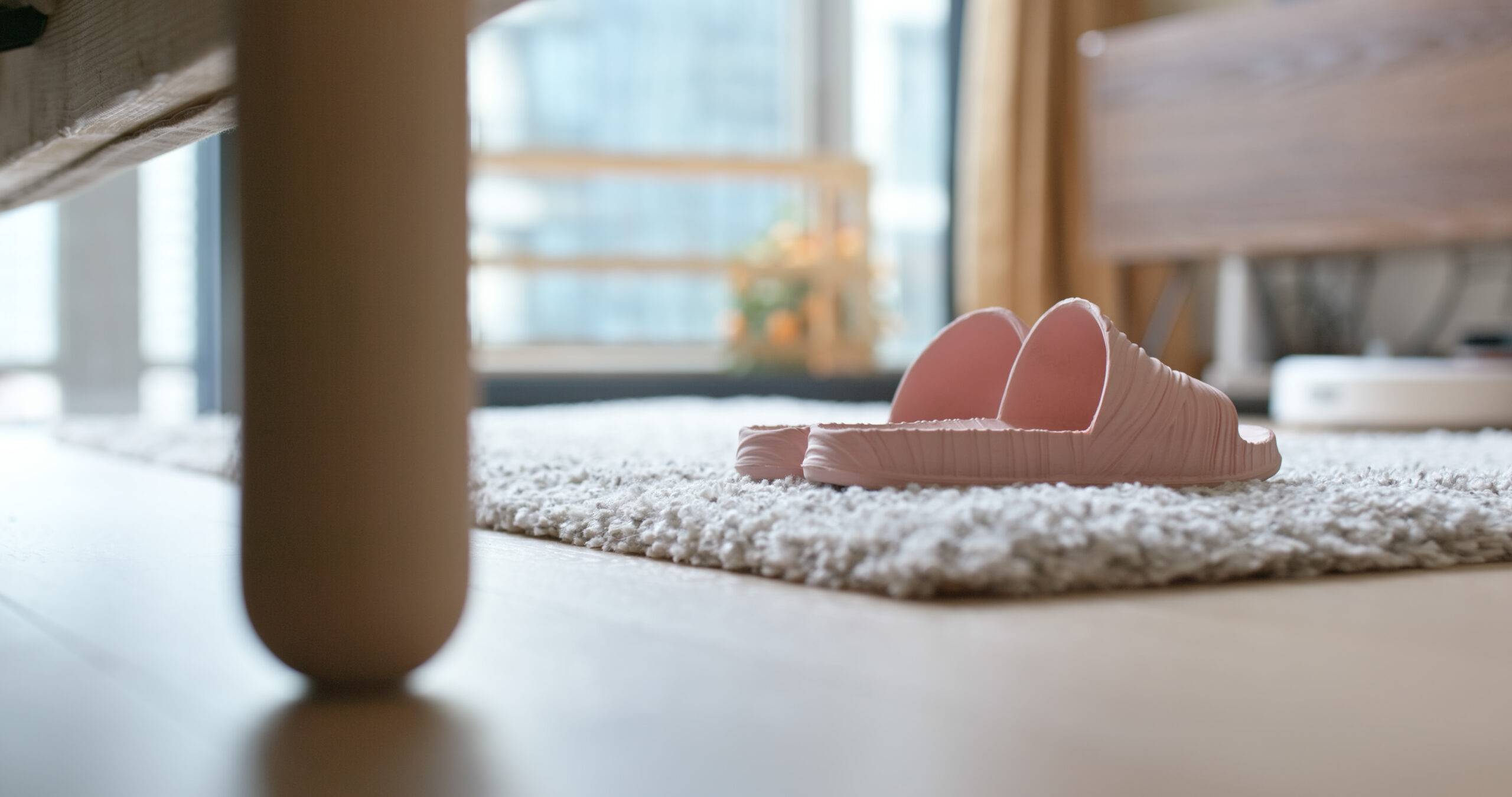Low angle shot of some sandels on a plush rug.
