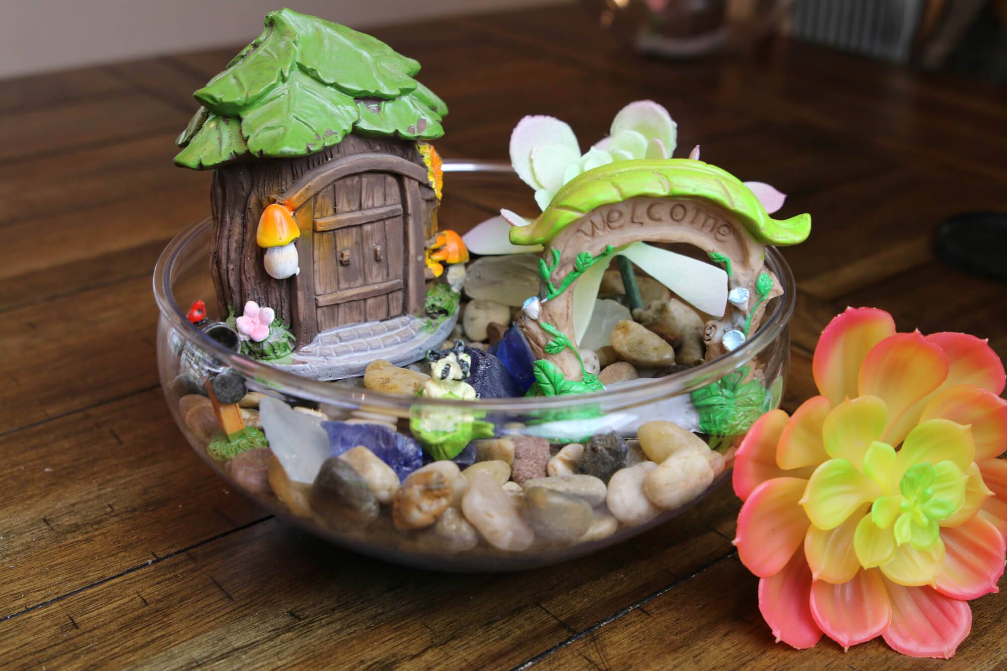 House and pebbles inside a clear glass
