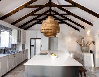 A large modern kitchen with visible ceiling strats.