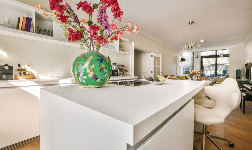 A low shot of a kitchen island with a smooth white countertop.