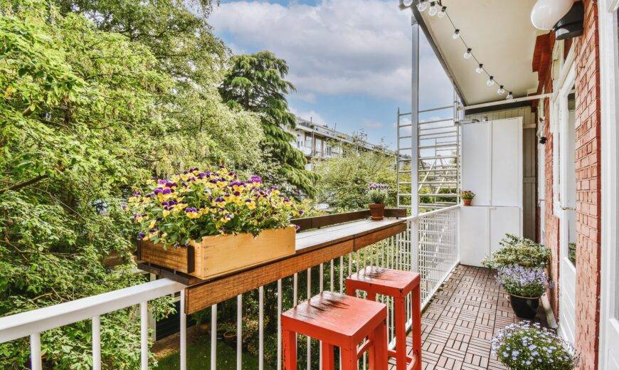 A narrow balcony with a small table built into the railing.