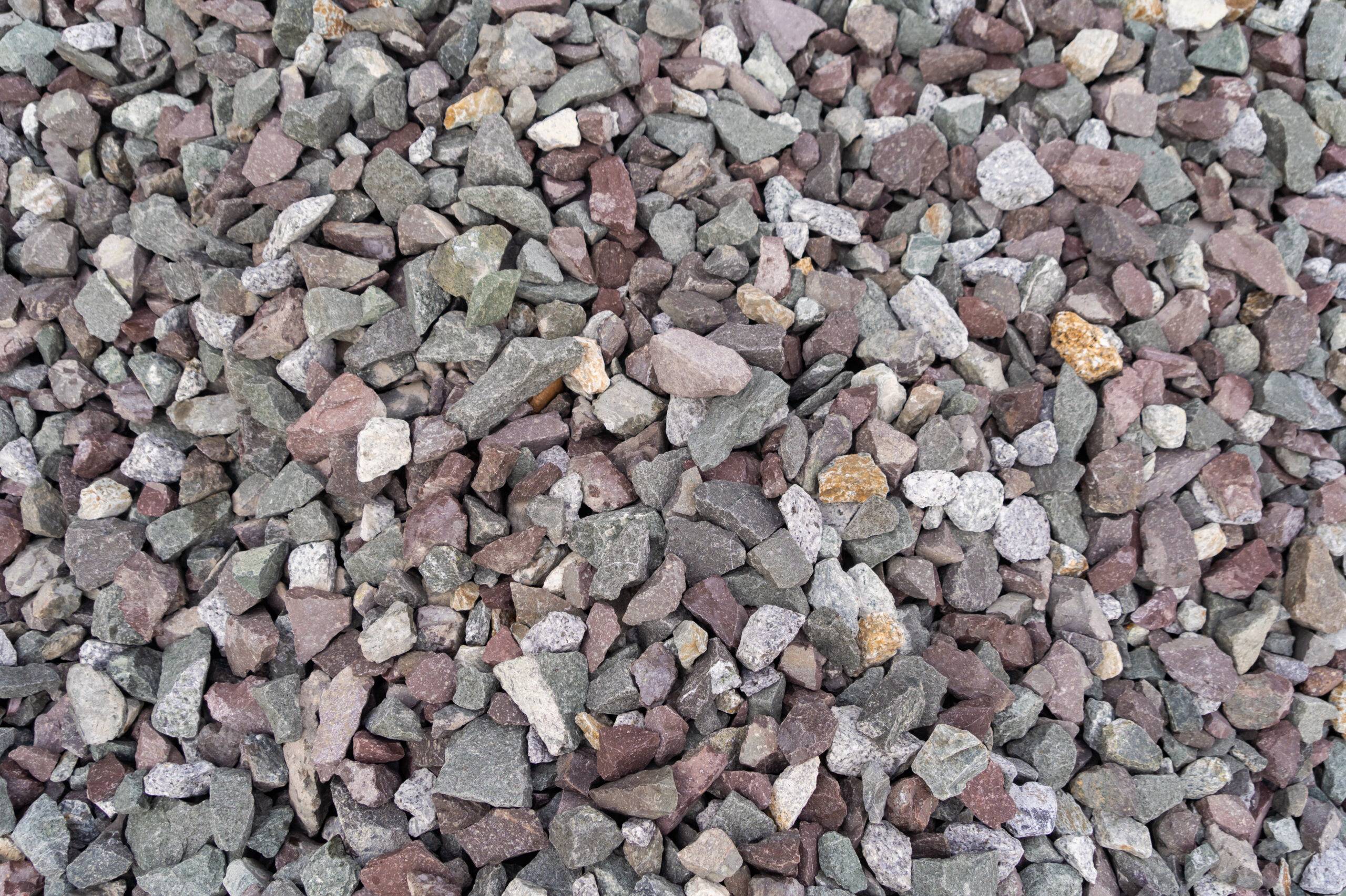 White granite gravel stones flooring pattern surface texture. Close-up of exterior material for design decoration background