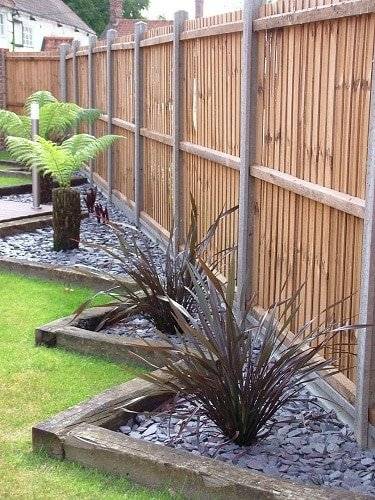 railway ties as garden edging stone mulch gardens with palm grass