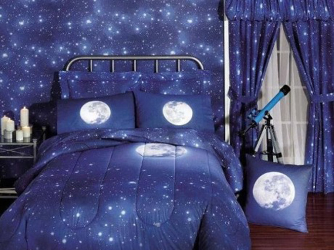 Space children's room with moon-themed comforter and a blue telescope.