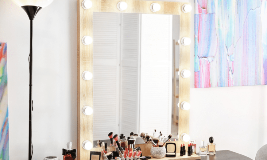 A makeup vanity with lights all around the frame.