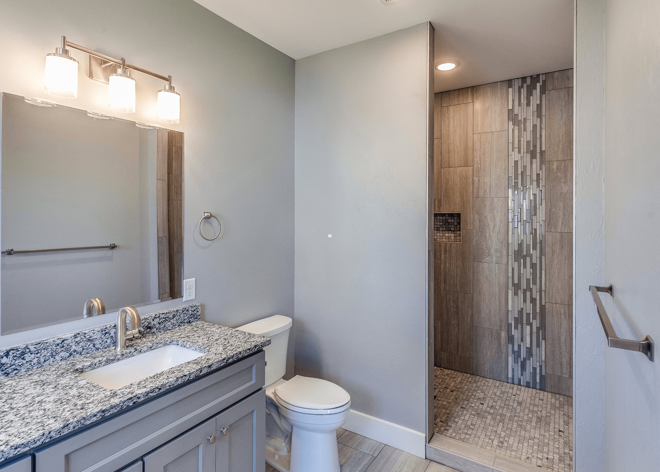 bathroom with walk in shower marble countertop